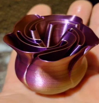 Purple metallic rose-shaped object held in a hand with product description and ratings on the left.